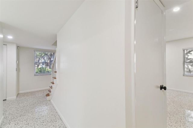 hall with light speckled floor, recessed lighting, stairway, and baseboards