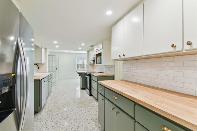 kitchen featuring stainless steel appliances, butcher block countertops, white cabinetry, and green cabinetry