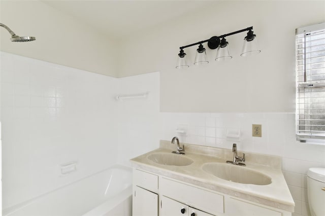 full bath with a garden tub, a sink, toilet, and tile walls