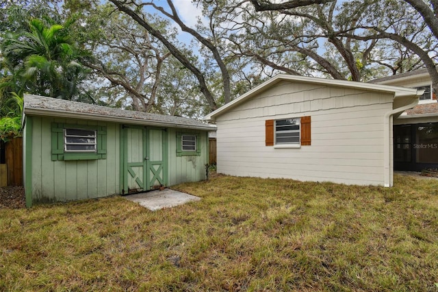 exterior space with a yard, a storage unit, and an outdoor structure