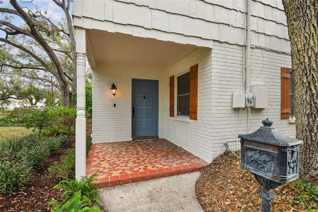 property entrance featuring brick siding