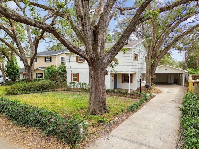 view of front of house featuring concrete driveway, brick siding, and a front yard