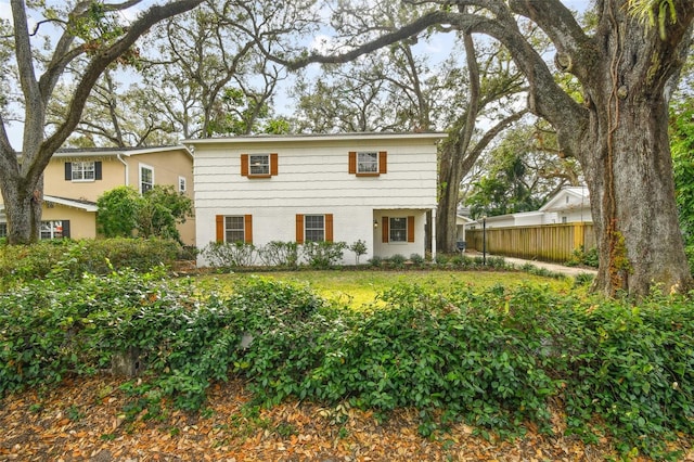 view of front of home with fence and brick siding