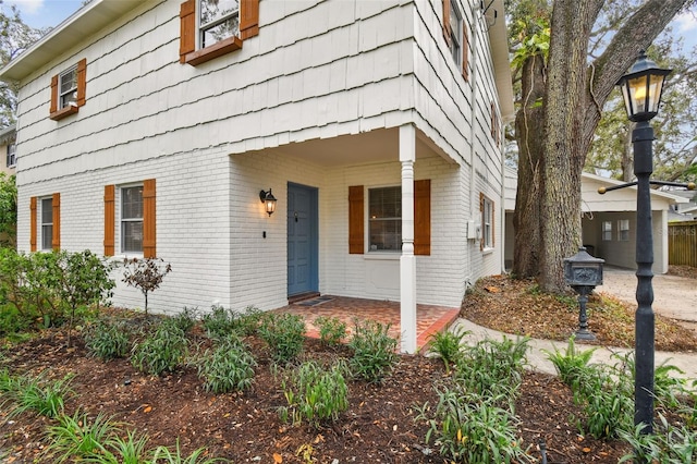 view of exterior entry featuring brick siding