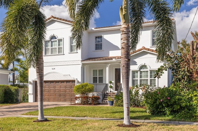 mediterranean / spanish-style house featuring a porch, a front yard, and a garage