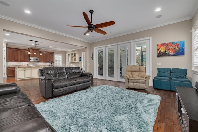 living room featuring dark wood-type flooring, french doors, sink, crown molding, and ceiling fan