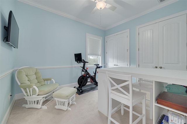 office space featuring ceiling fan, light colored carpet, and ornamental molding