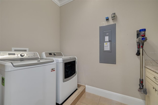 laundry room with cabinets, washer and clothes dryer, crown molding, electric panel, and light tile patterned flooring