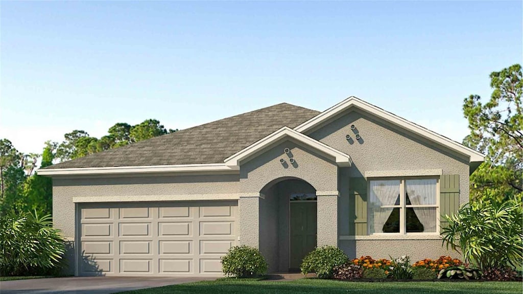 view of front of house featuring a garage and a front yard