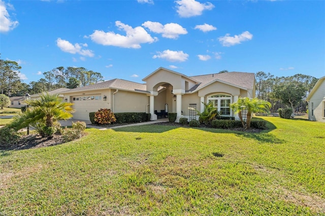 view of front of property with a front yard and a garage