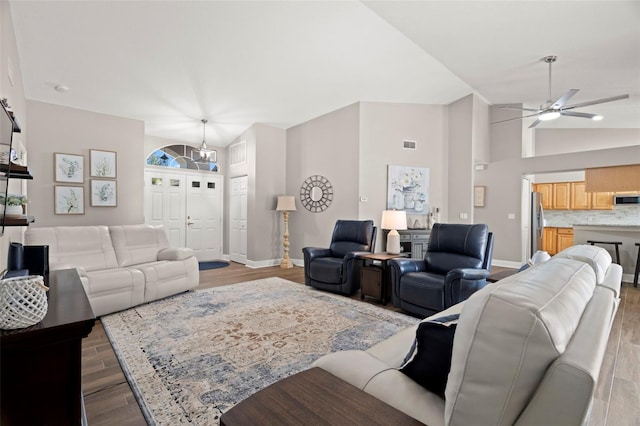 living room featuring light hardwood / wood-style flooring, vaulted ceiling, and ceiling fan