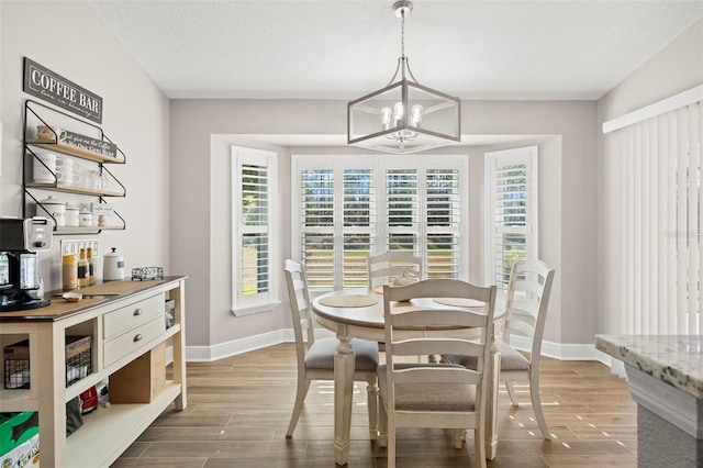 dining room with a chandelier and a textured ceiling