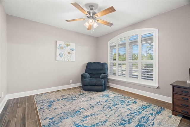 sitting room featuring dark hardwood / wood-style floors and ceiling fan