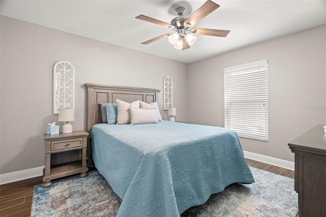 bedroom featuring ceiling fan and dark wood-type flooring