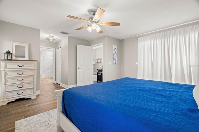 bedroom with ceiling fan and ensuite bath