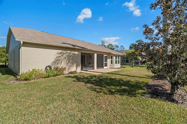 rear view of house with a patio and a yard