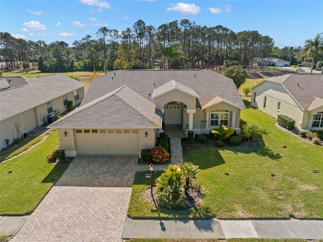 view of front of home featuring a garage and a front lawn