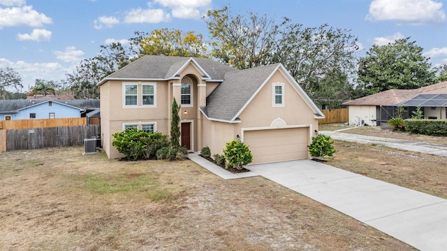 view of front of property featuring central AC unit and a garage