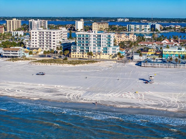 drone / aerial view featuring a water view and a beach view