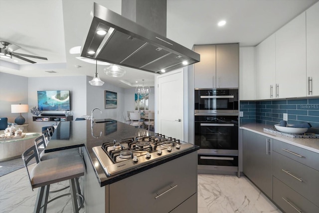 kitchen featuring island exhaust hood, stainless steel appliances, a kitchen island with sink, gray cabinets, and white cabinetry