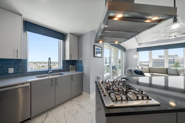 kitchen with gray cabinets, a wealth of natural light, sink, and stainless steel appliances