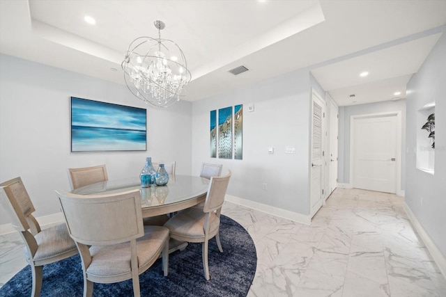 dining room featuring a tray ceiling and a chandelier