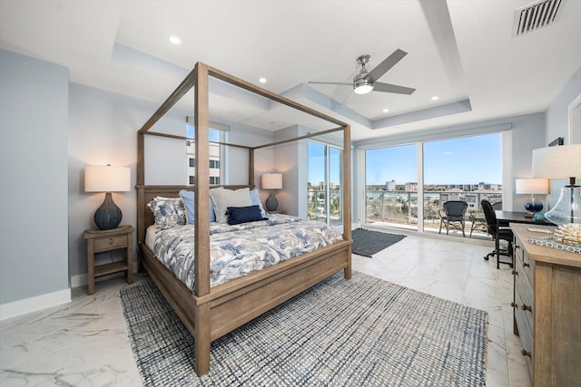 bedroom featuring a tray ceiling and ceiling fan