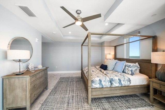 bedroom featuring a tray ceiling and ceiling fan