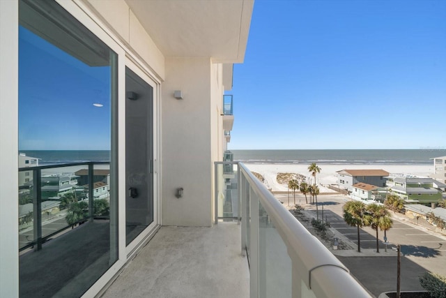 balcony with a water view and a beach view