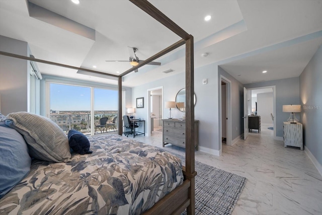 bedroom featuring ceiling fan and a tray ceiling