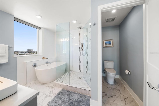 bathroom featuring separate shower and tub and toilet