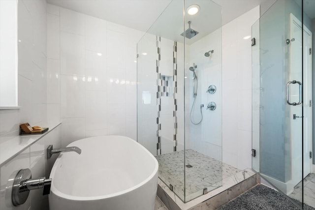 bathroom with tile walls and plus walk in shower