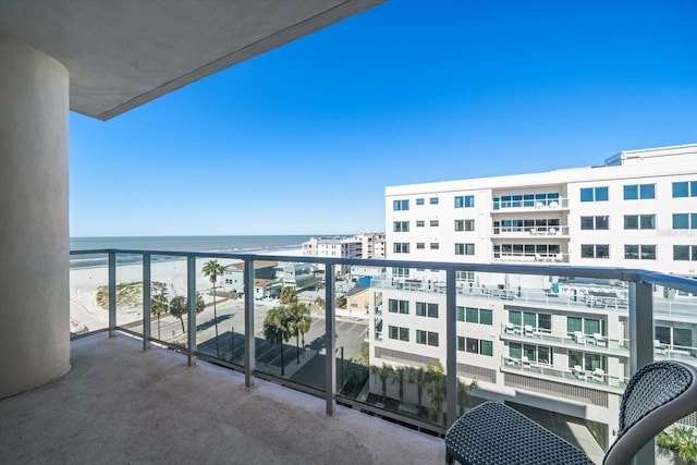 balcony featuring a water view and a view of the beach