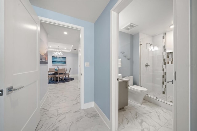 bathroom with vanity, toilet, walk in shower, and an inviting chandelier