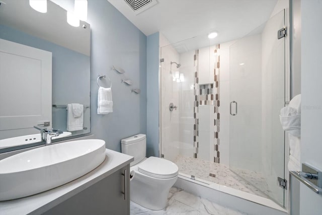 bathroom featuring vanity, toilet, and an enclosed shower