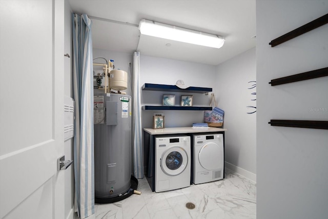 washroom with water heater and washer and dryer