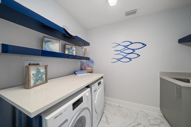 clothes washing area featuring washing machine and clothes dryer and sink