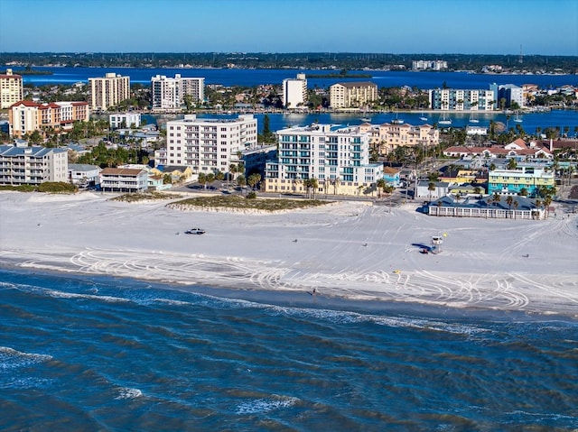 bird's eye view featuring a water view and a beach view