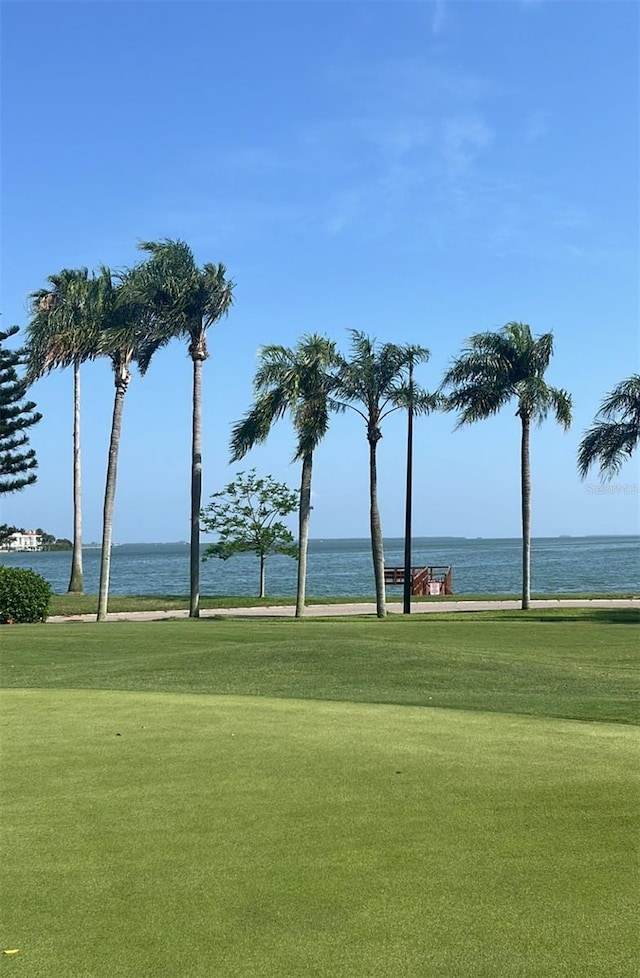 view of property's community with a yard and a water view