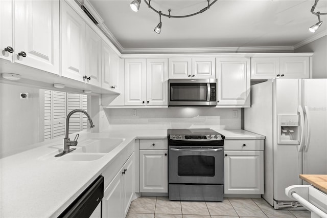 kitchen with sink, light tile patterned floors, crown molding, white cabinets, and appliances with stainless steel finishes