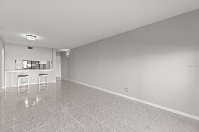 unfurnished living room with light tile patterned floors