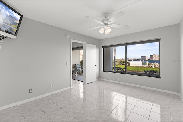 unfurnished room featuring ceiling fan and light tile patterned floors