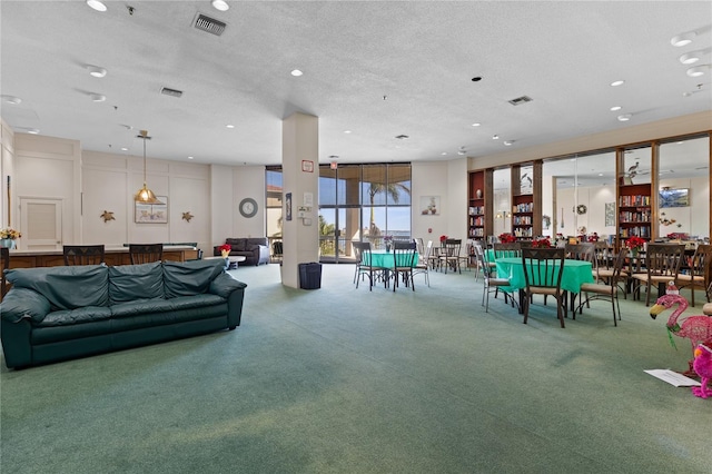 rec room featuring carpet flooring and a textured ceiling