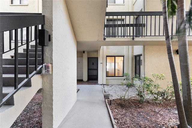 view of exterior entry with a balcony