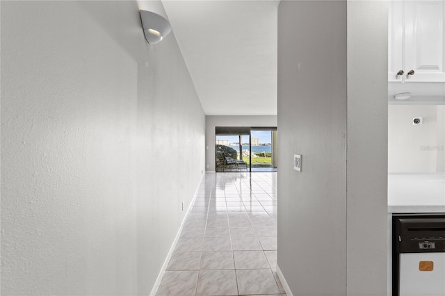 corridor featuring light tile patterned floors