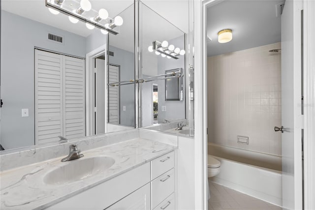 full bathroom featuring vanity, toilet, and tiled shower / bath