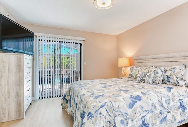 bedroom with light wood-type flooring and access to outside