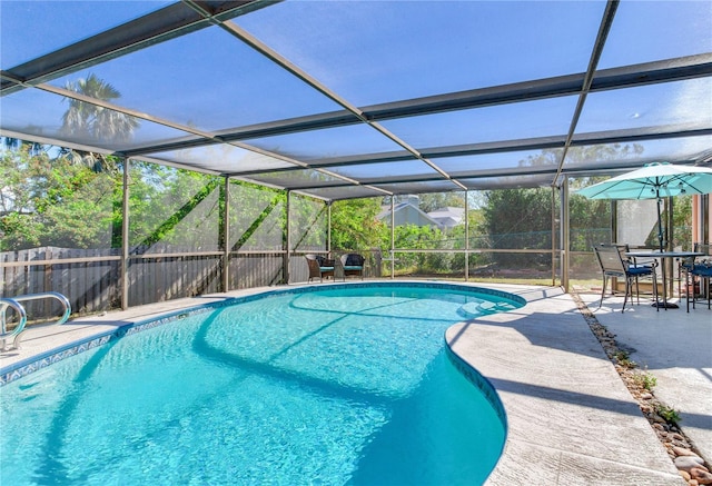 view of swimming pool featuring a lanai and a patio area