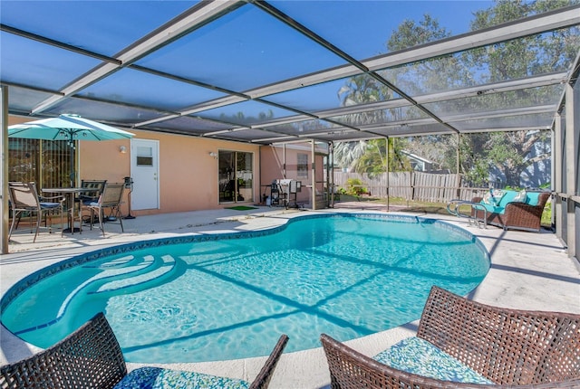 view of swimming pool with a lanai and a patio area