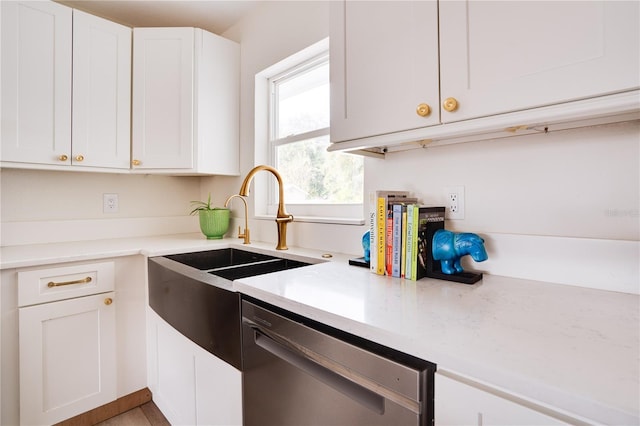 kitchen with sink, stainless steel dishwasher, and white cabinets